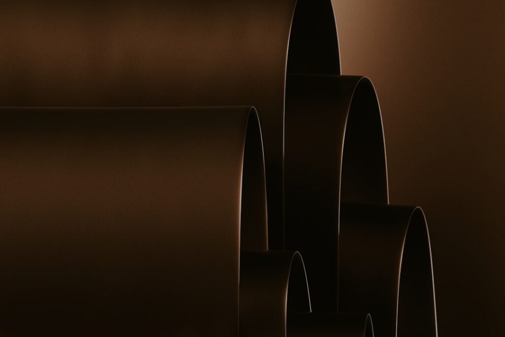Layered dark brown curved shapes create an architectural pattern.